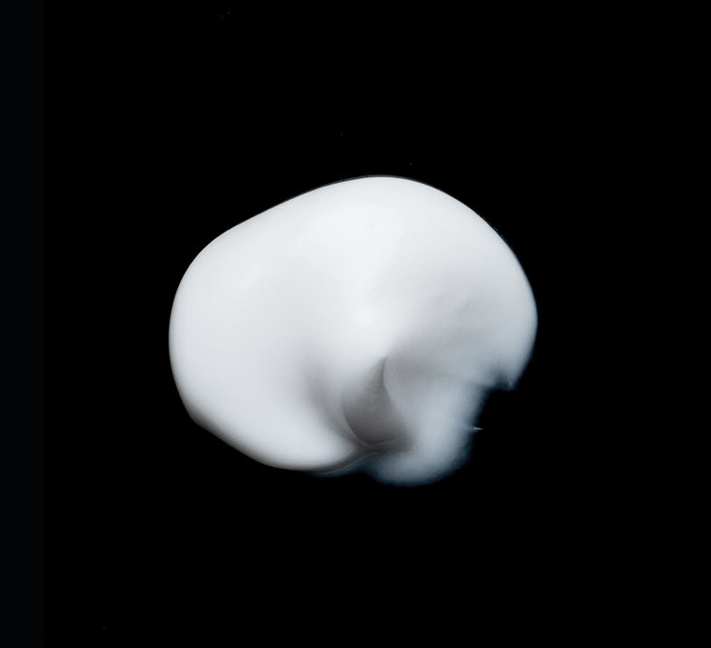 Canadian skincare cream applied on a black background
