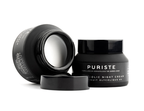 Black jars of Canadian skincare brand Puriste Glycolic Night Cream on a white background